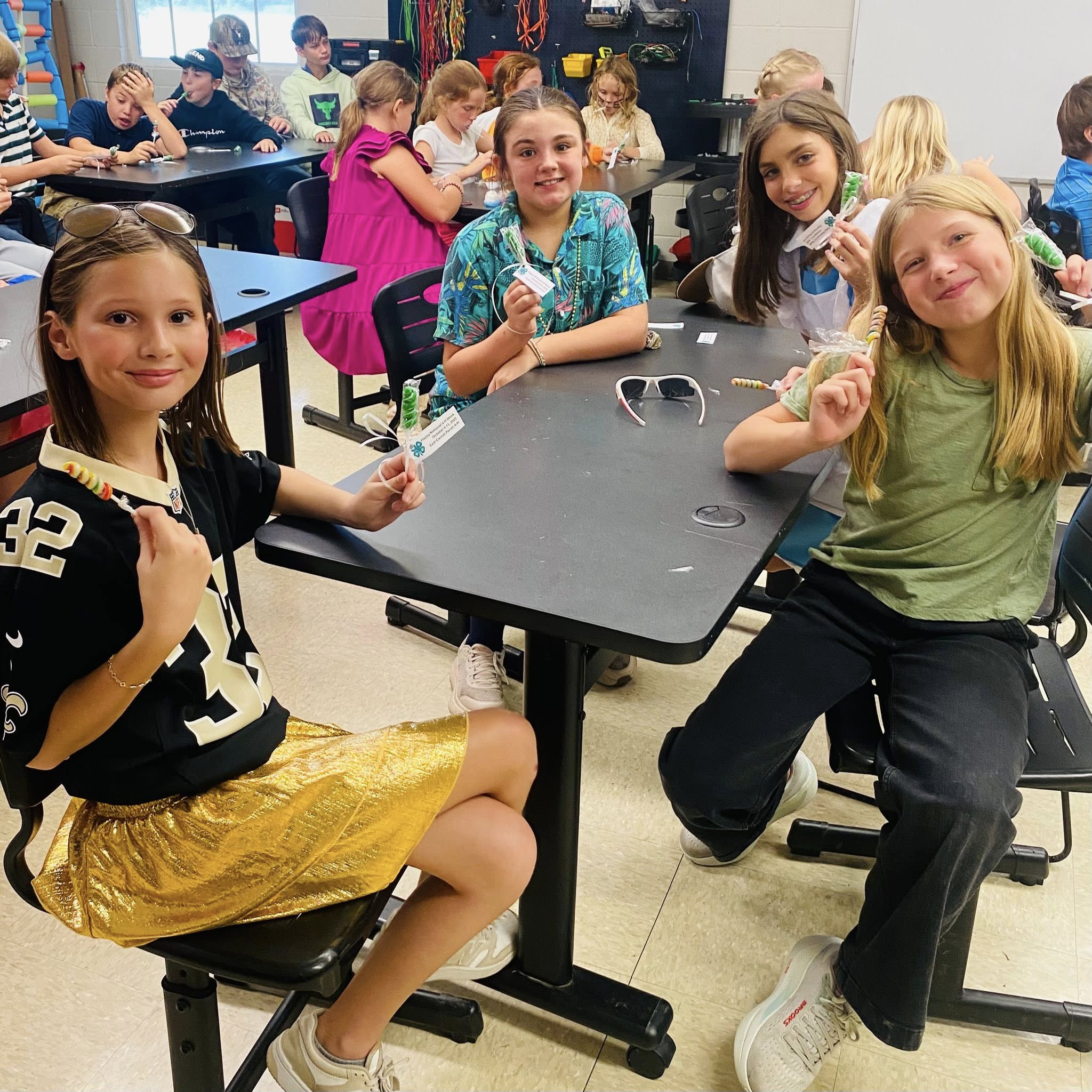 Kids at a table posing for a photo.